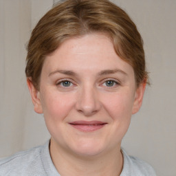 Joyful white young-adult female with medium  brown hair and blue eyes