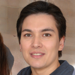 Joyful white young-adult male with medium  brown hair and brown eyes