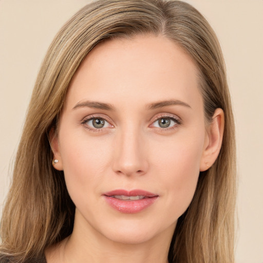 Joyful white young-adult female with long  brown hair and green eyes