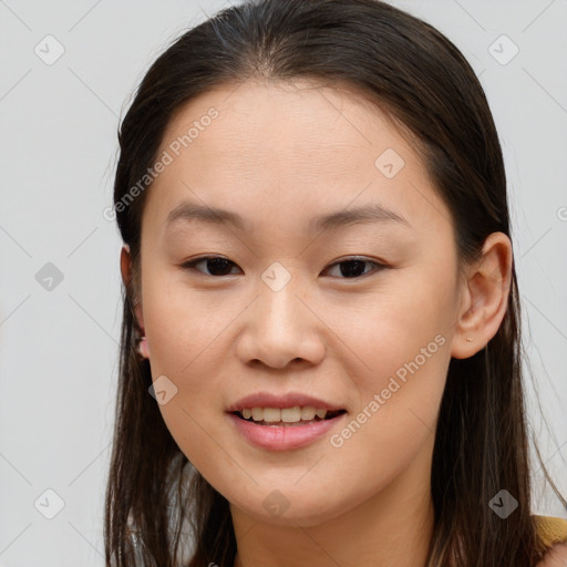 Joyful asian young-adult female with long  brown hair and brown eyes