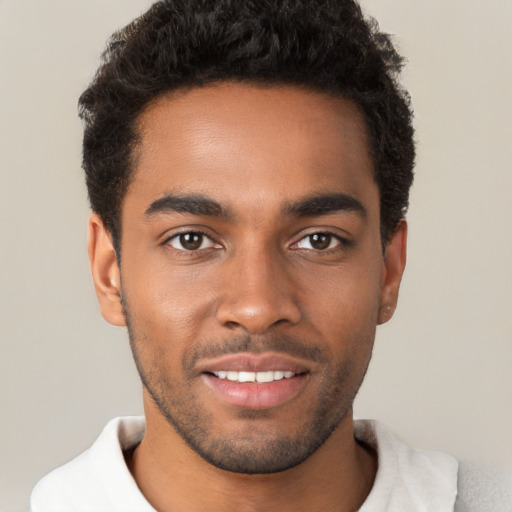 Joyful black young-adult male with short  black hair and brown eyes