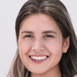 Joyful white young-adult female with long  brown hair and blue eyes