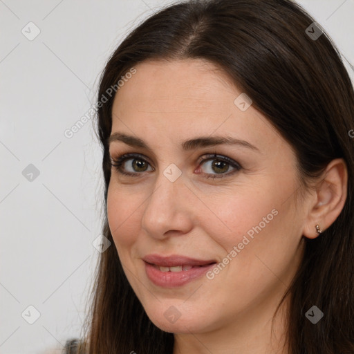 Joyful white young-adult female with long  brown hair and brown eyes