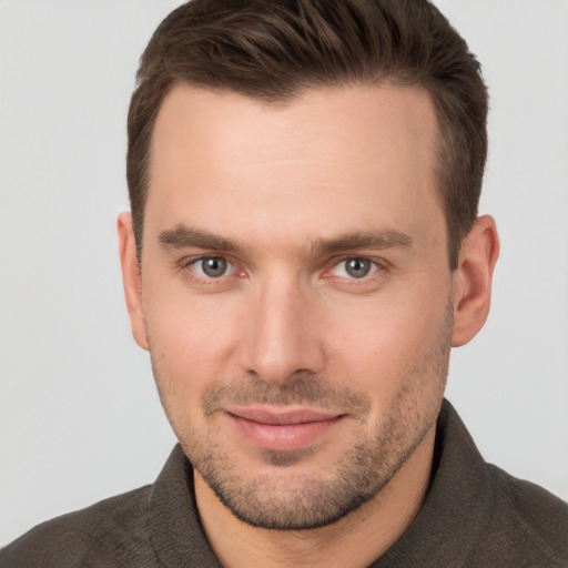 Joyful white young-adult male with short  brown hair and brown eyes