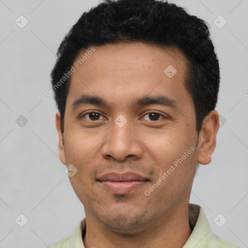 Joyful latino young-adult male with short  black hair and brown eyes