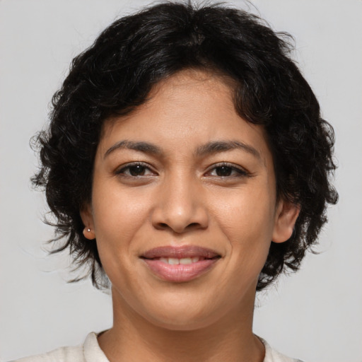 Joyful latino young-adult female with medium  brown hair and brown eyes