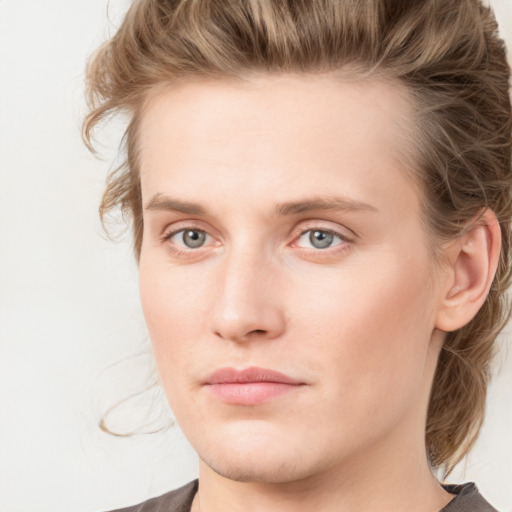 Joyful white young-adult male with medium  brown hair and blue eyes