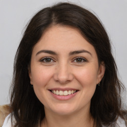 Joyful white young-adult female with medium  brown hair and brown eyes