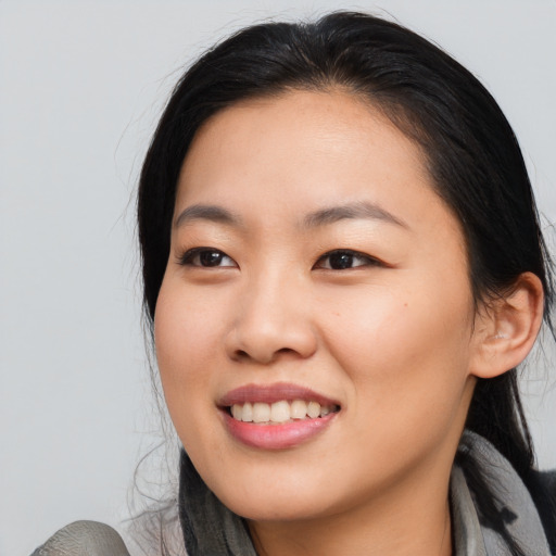 Joyful asian young-adult female with medium  black hair and brown eyes