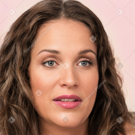 Joyful white young-adult female with long  brown hair and green eyes