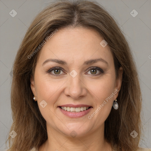 Joyful white adult female with long  brown hair and brown eyes