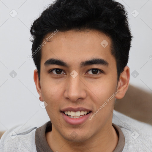 Joyful latino young-adult male with short  brown hair and brown eyes