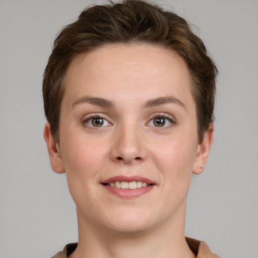 Joyful white young-adult female with short  brown hair and grey eyes