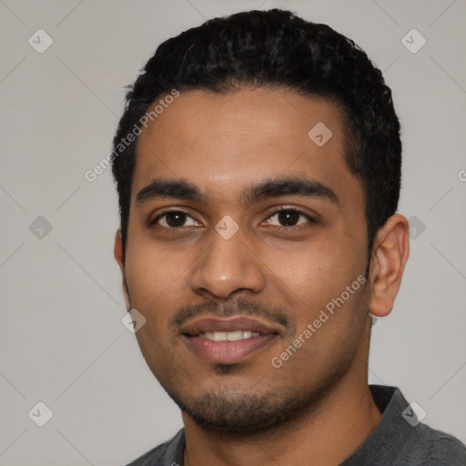 Joyful latino young-adult male with short  black hair and brown eyes