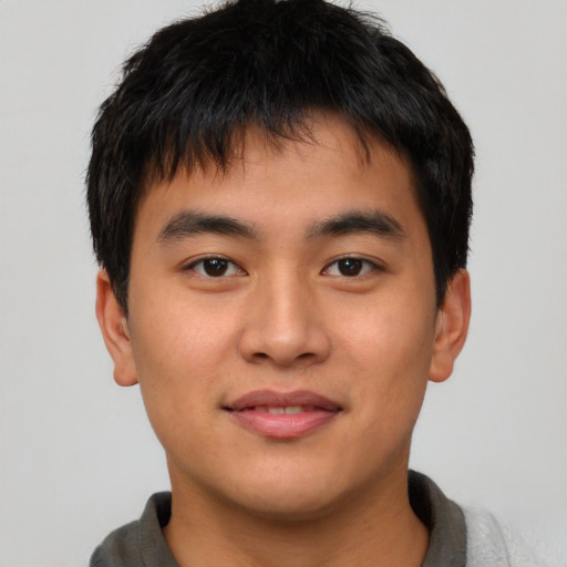 Joyful asian young-adult male with short  brown hair and brown eyes