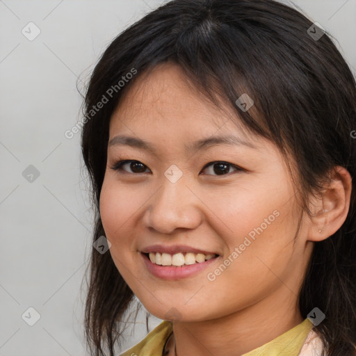 Joyful asian young-adult female with medium  brown hair and brown eyes