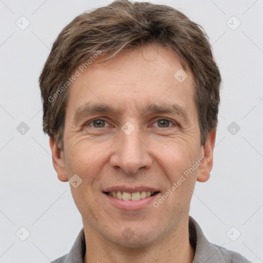 Joyful white adult male with short  brown hair and grey eyes