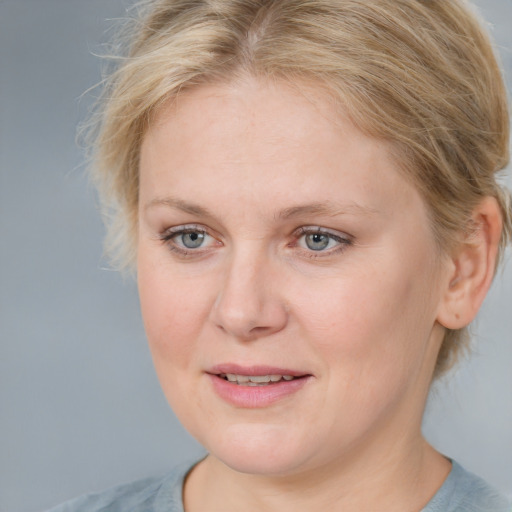 Joyful white young-adult female with medium  brown hair and blue eyes