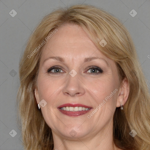 Joyful white adult female with medium  brown hair and blue eyes