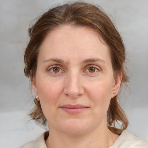 Joyful white adult female with medium  brown hair and blue eyes