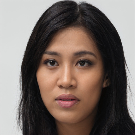 Joyful asian young-adult female with long  black hair and brown eyes