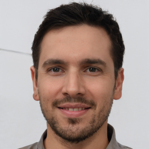 Joyful white young-adult male with short  brown hair and brown eyes