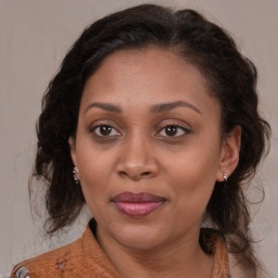 Joyful black young-adult female with medium  brown hair and brown eyes