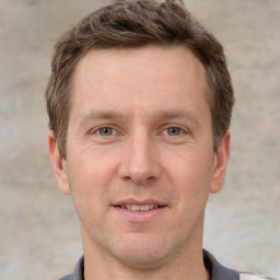 Joyful white adult male with short  brown hair and grey eyes