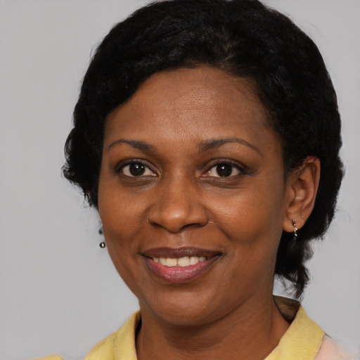 Joyful latino adult female with short  brown hair and brown eyes