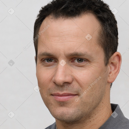 Joyful white adult male with short  brown hair and brown eyes