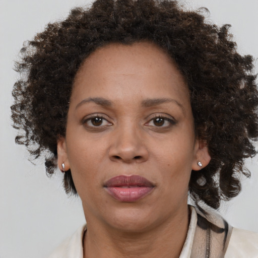 Joyful black adult female with medium  brown hair and brown eyes