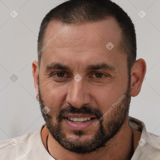 Joyful white adult male with short  brown hair and brown eyes