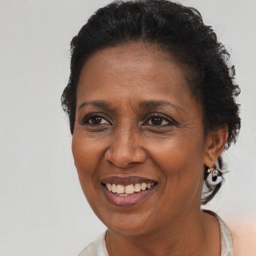 Joyful black adult female with short  brown hair and brown eyes