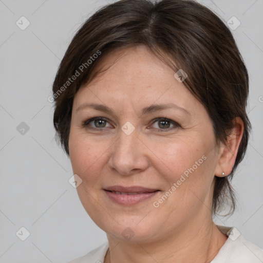 Joyful white adult female with medium  brown hair and brown eyes