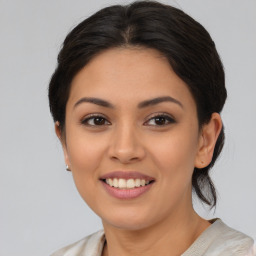 Joyful latino young-adult female with medium  brown hair and brown eyes