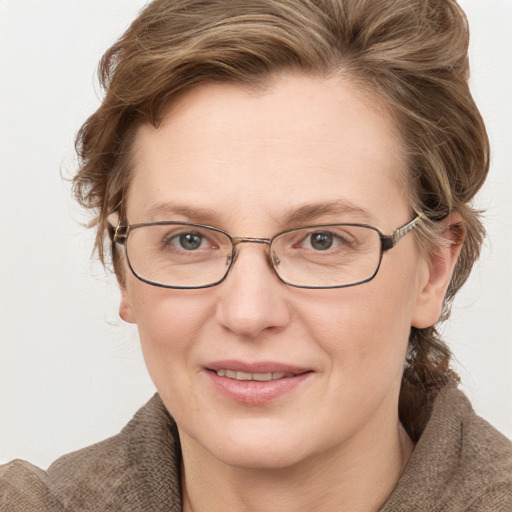 Joyful white adult female with medium  brown hair and blue eyes