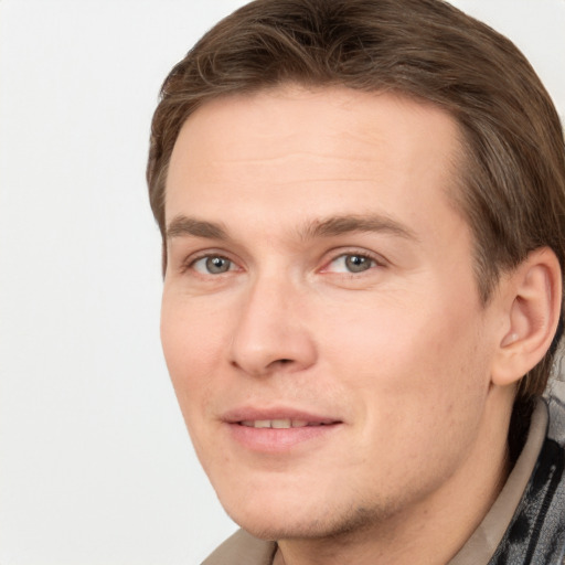 Joyful white young-adult male with short  brown hair and grey eyes