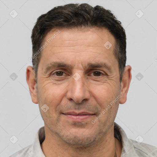 Joyful white adult male with short  brown hair and brown eyes