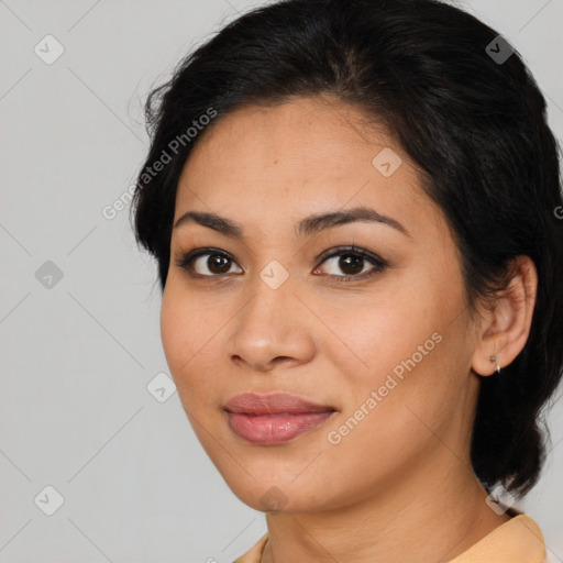 Joyful latino young-adult female with medium  brown hair and brown eyes