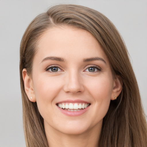 Joyful white young-adult female with long  brown hair and grey eyes