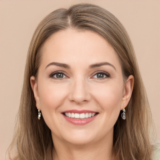 Joyful white young-adult female with long  brown hair and grey eyes