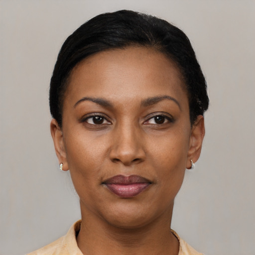 Joyful latino young-adult female with short  black hair and brown eyes