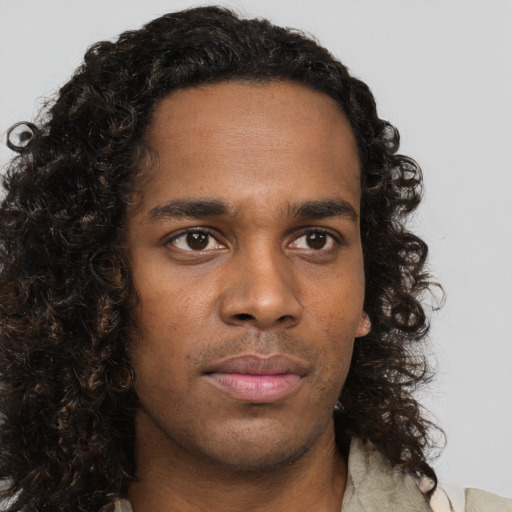 Neutral black young-adult male with long  brown hair and brown eyes