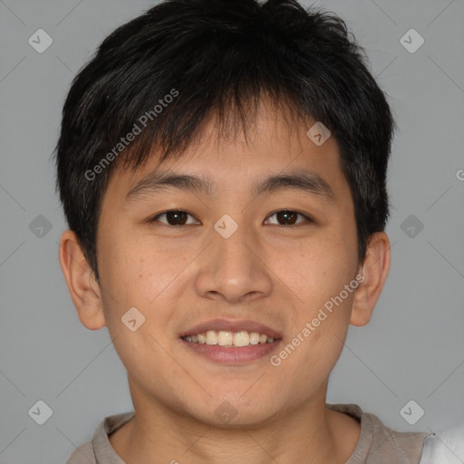 Joyful asian young-adult male with short  brown hair and brown eyes