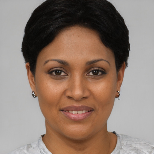 Joyful black young-adult female with short  brown hair and brown eyes