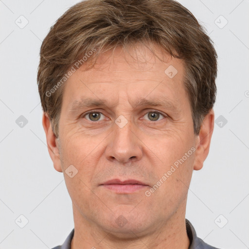 Joyful white adult male with short  brown hair and grey eyes