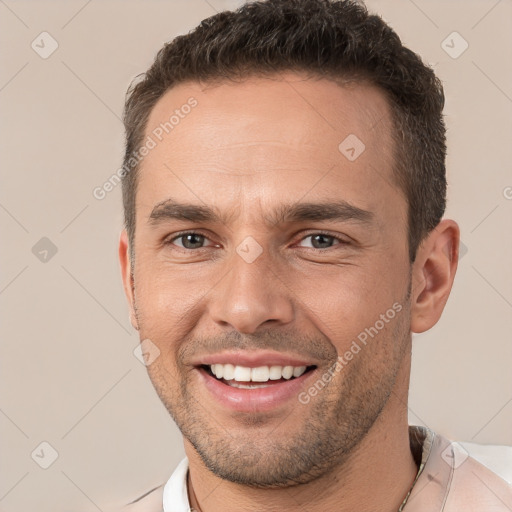 Joyful white young-adult male with short  brown hair and brown eyes