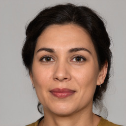 Joyful white adult female with medium  brown hair and brown eyes