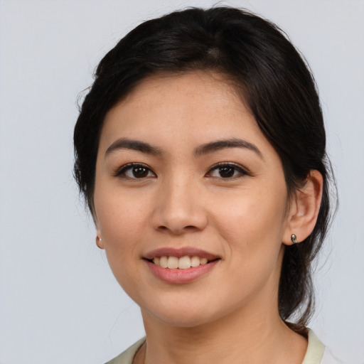 Joyful asian young-adult female with medium  brown hair and brown eyes