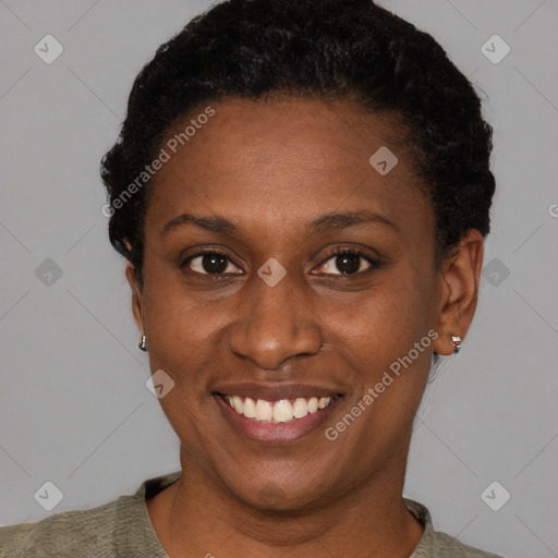 Joyful black adult female with short  black hair and brown eyes